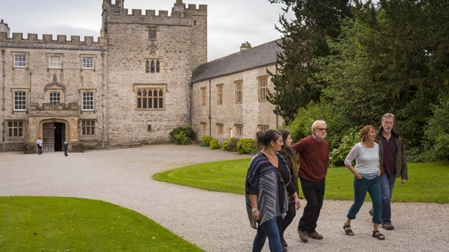 Visitors walking in the courtyard outside the house at Sizergh, Cumbria